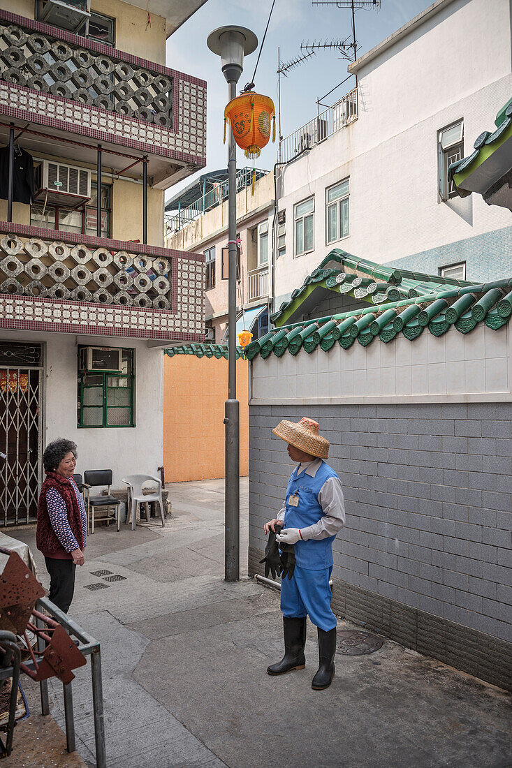 locals having conversation at alleys of Cheng Chau Island, Hongkong, China, Asia