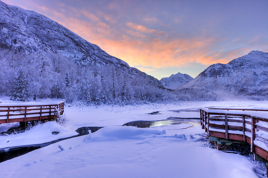 Colorful sunrise over a stream and the salmon viewing deck at the Eagle River Nature Center in Chugach State Park, Southcentral Alaska, Winter, HDR