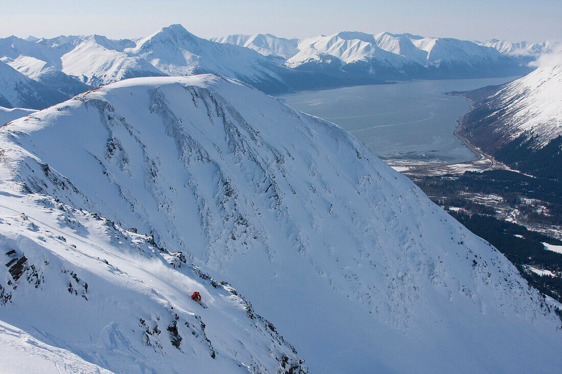 Downhill Skier On Max's Mountain Overlooking Girdwood And The Turnagain Arm And Kenai Mountains, Southcentral Alaska, Winter