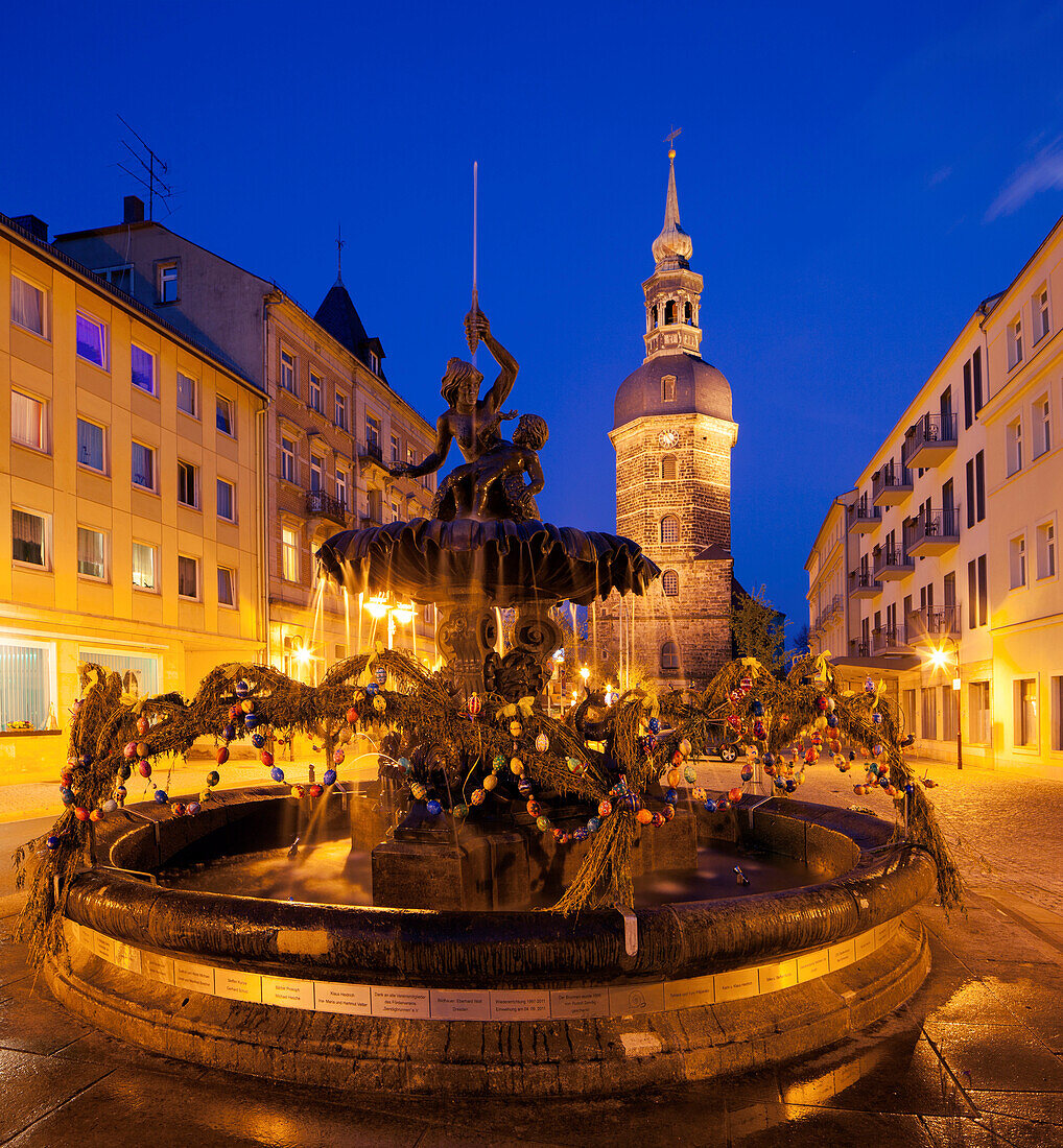 View of the market of Bad Schandau with St. John's Church and Sendigbrunnen in blue dusk, Saxon Switzerland, Saxony, Germany