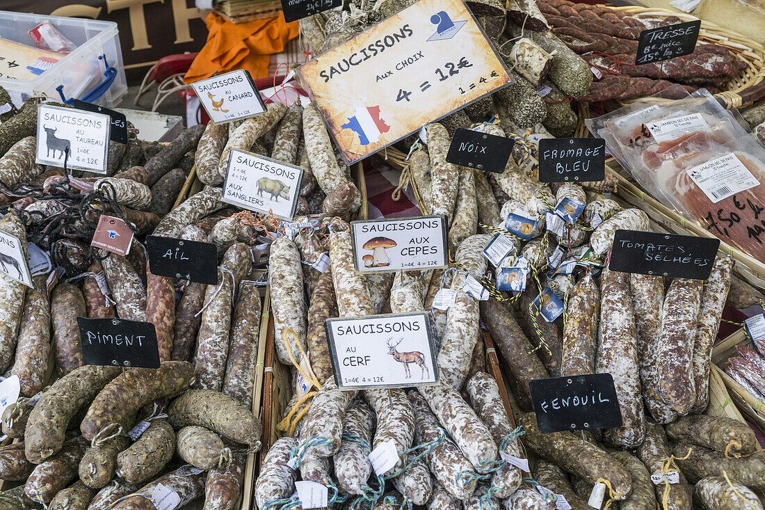 Suassages and salami on the market stall in Lourmarin, Provence-Alpes-Cote d’Azur, France
