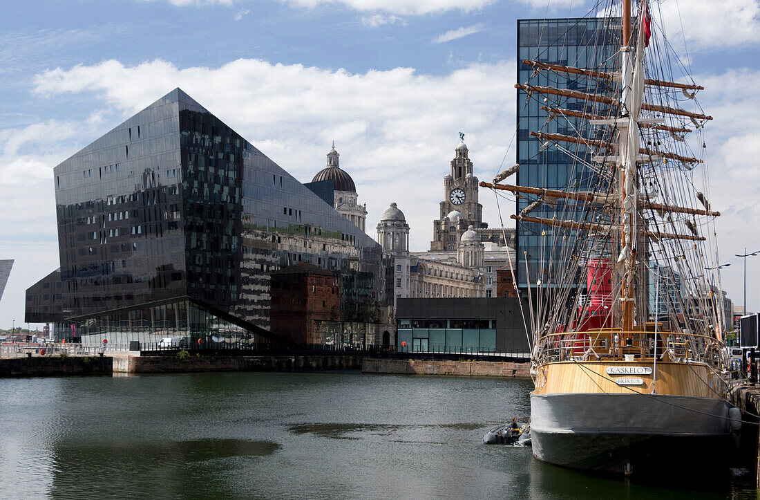 Part of Port of Liverpool Building and Royal Liver Building seen across Canning Dock with sailing ship Kaskelot, Liverpool, Merseyside, England, United Kingodm, Europe