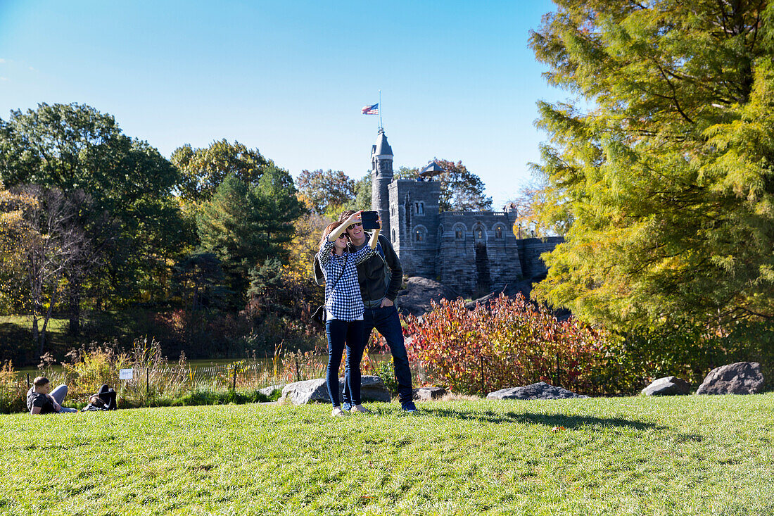 Tourists posing in front of Belvedere Castle, Central Park, Manhattan, New York City, USA, America