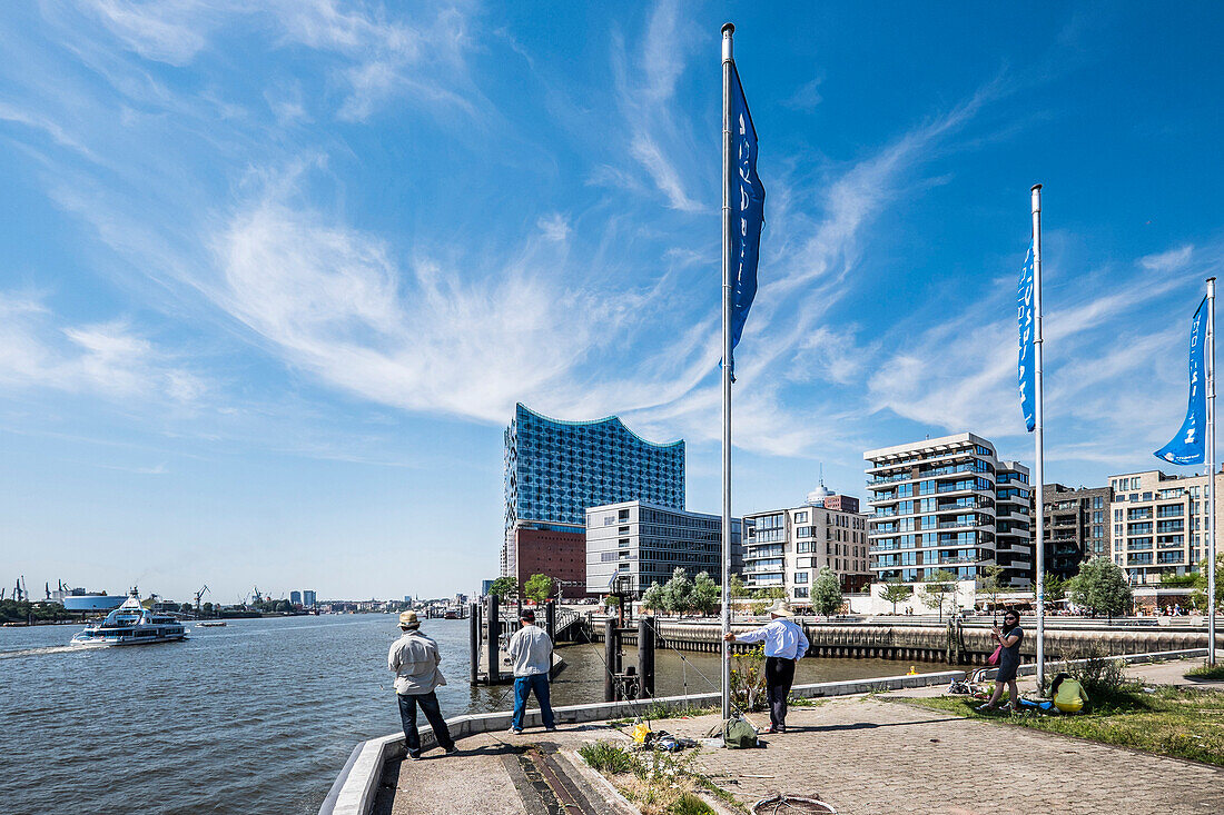 people fishing at Grasbrock harbour with view to the new Elbphilharmonie, Hafencity of Hamburg, north Germany, Germany