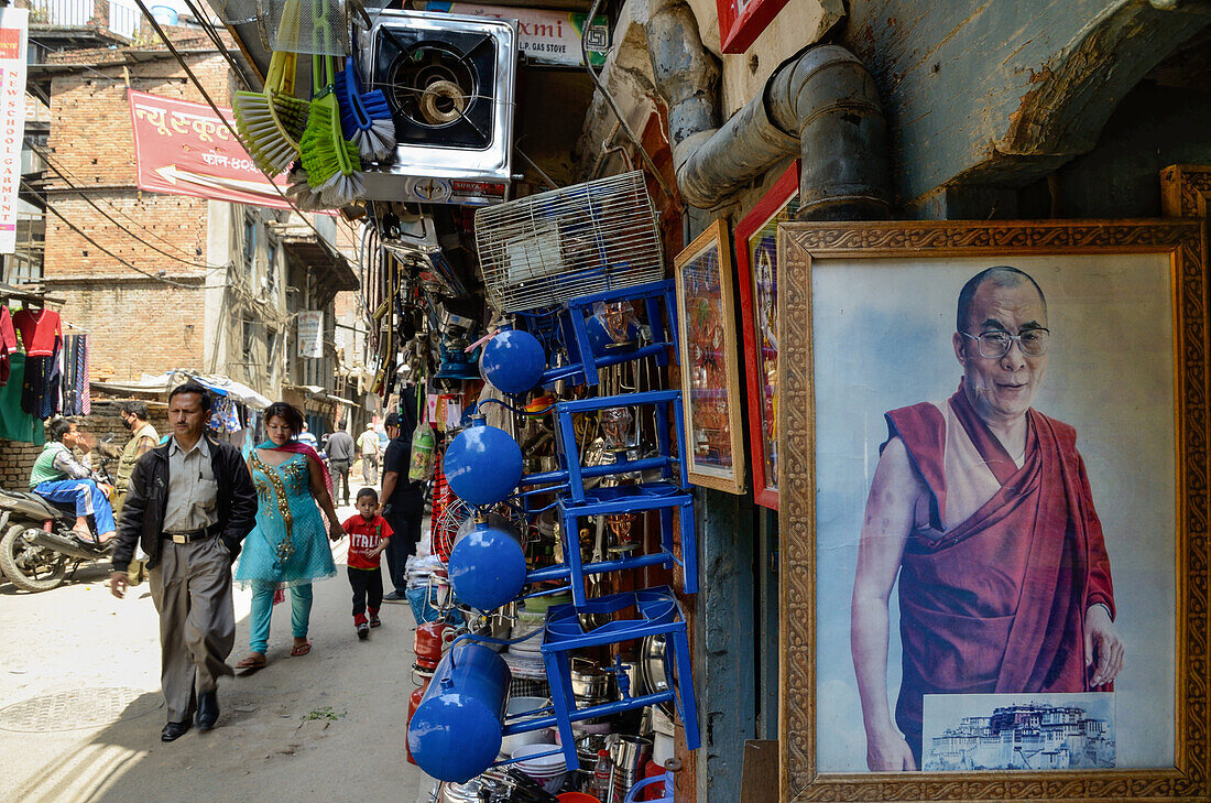 Shopping street in an old part of Thamel with a picture of the Dalai Lama, Kathmandu, Nepal, Himalaya, Asien