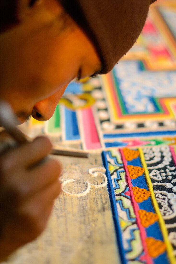 Buddhist monchs preparing a sand mandala with coloured wheat flour. The ceremony lasts for several days. Only very few visitors are granted entrance to this very seldom ceremony. Even less are allowed to take photographs. Lo Manthang (3840 m), former capi