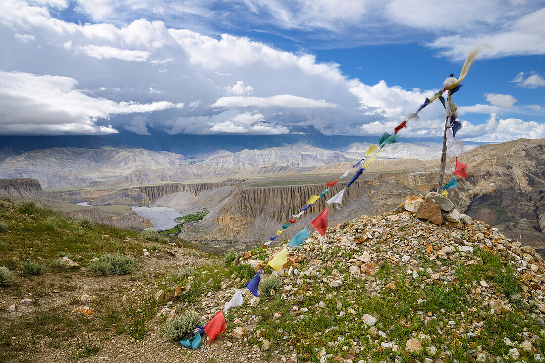 Prayer flags in front of Tangge, tibetian village with a buddhist Gompa in the Kali Gandaki valley, the deepest valley in the world, Mustang, Nepal, Himalaya, Asia