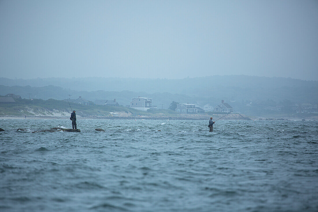 Fishing on the rocks in the water along the coast, Cape Cod, Massachusetts, United States of America