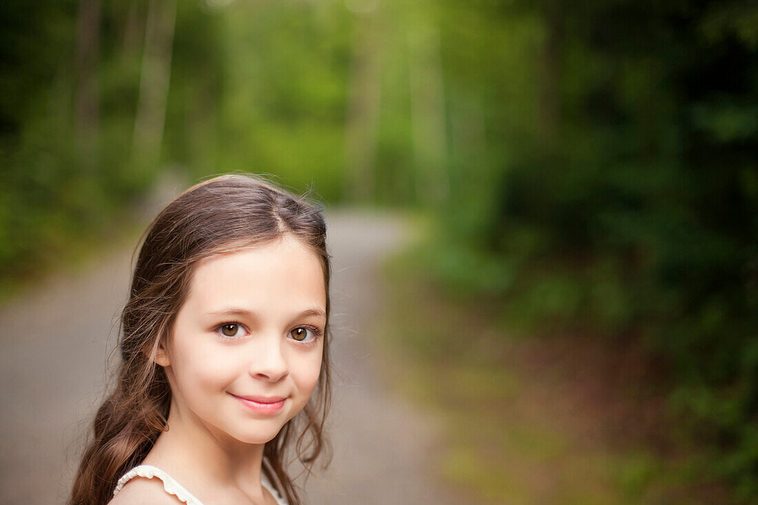 Caucasian girl smiling on dirt road