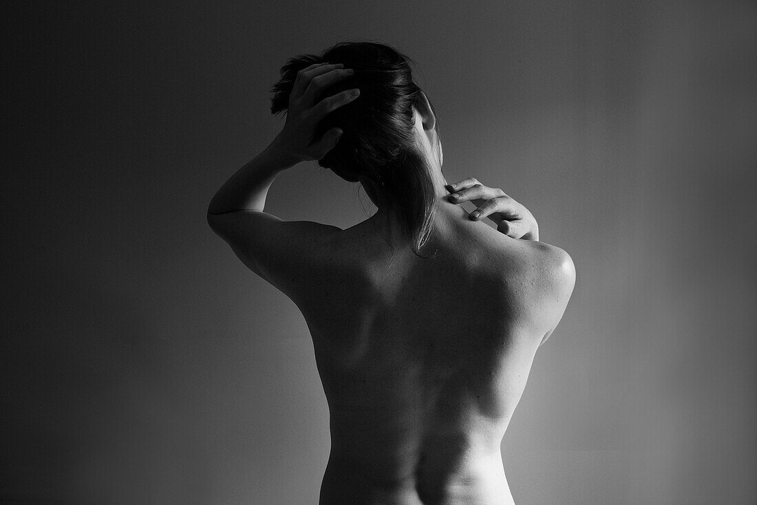 Muscular back of nude Caucasian woman