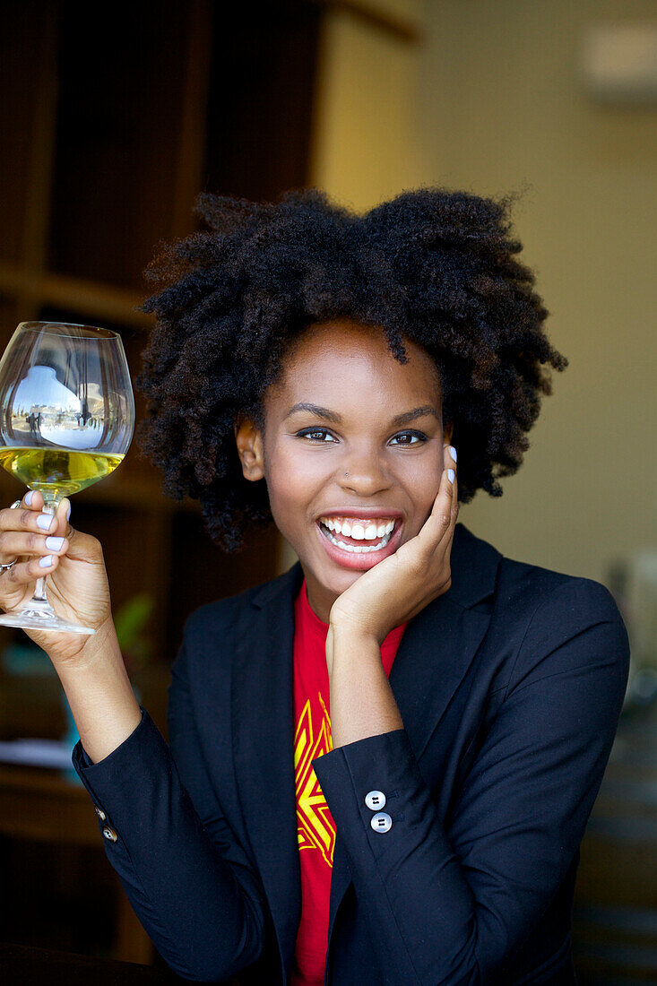 Smiling woman drinking glass of white wine