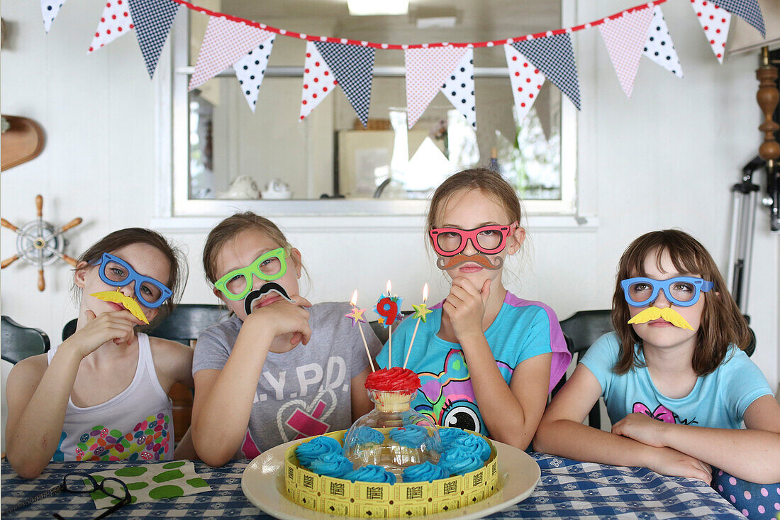 Children wearing disguises at birthday party