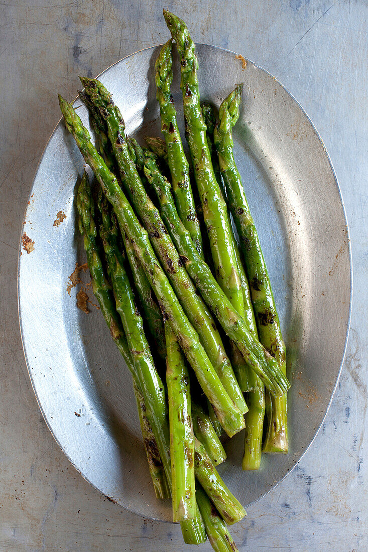 Close up of plate of grilled asparagus