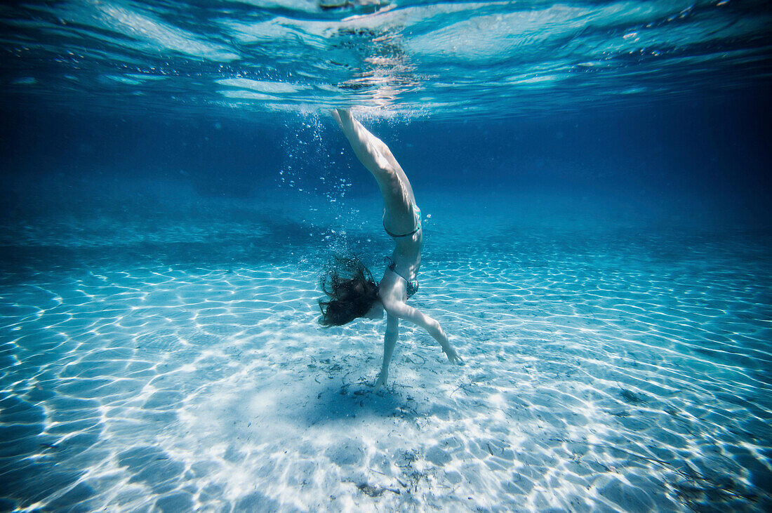 Underwater view of woman swimming in ocean