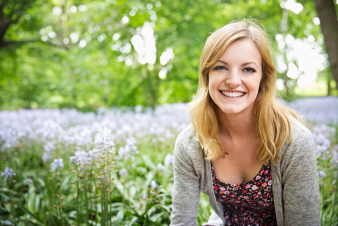 Caucasian woman smiling in field of flowers