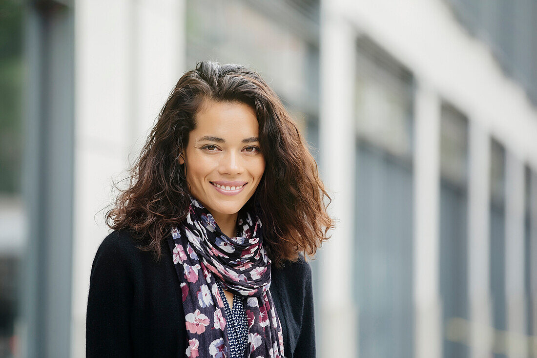 Mixed race woman smiling in city