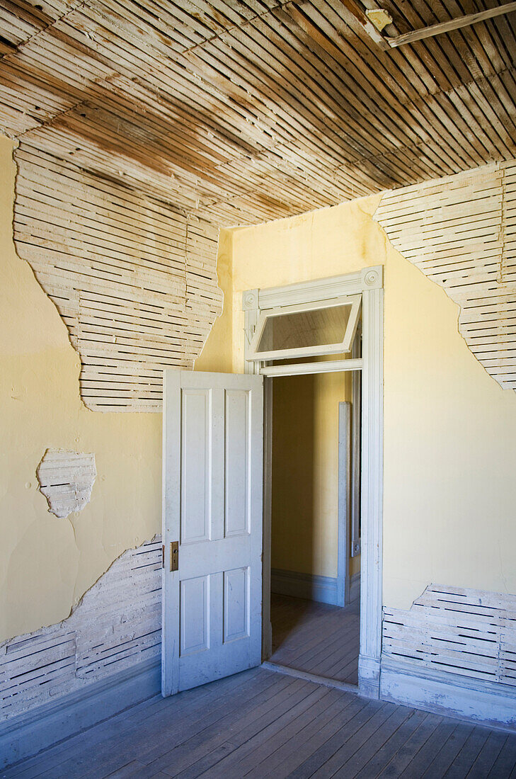 Open door of dilapidated room