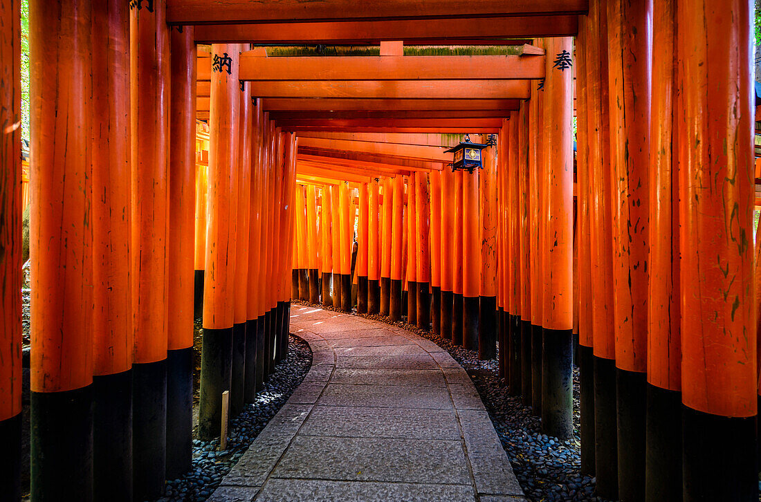 Walkway under orange wooden pillars