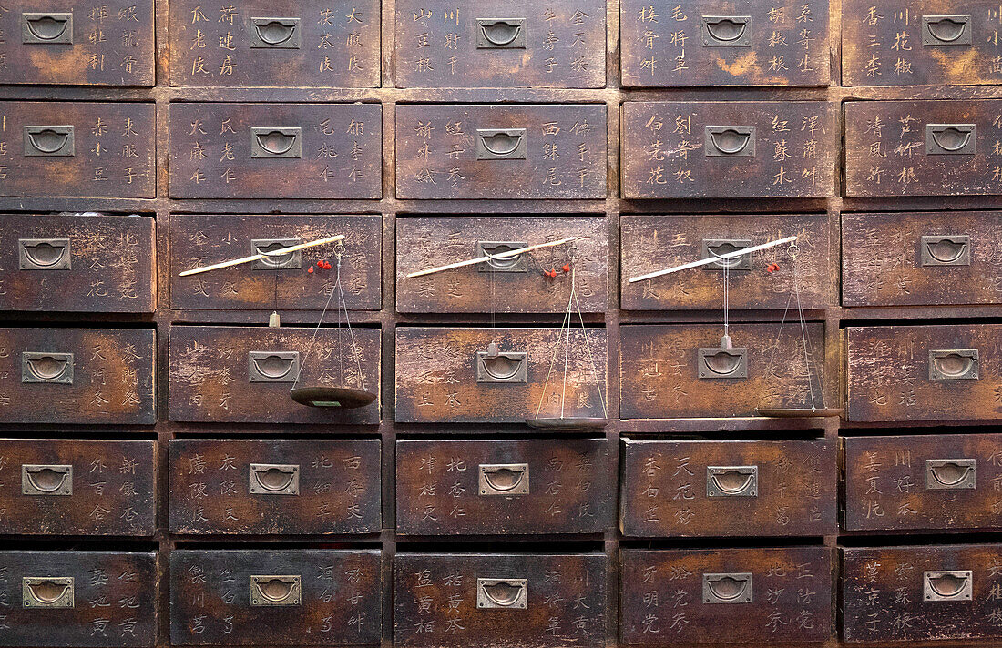 Old wooden drawers and scales in a Chinese pharmacy in  Melaka Malacca, Malaysia, Southeast Asia, Asia