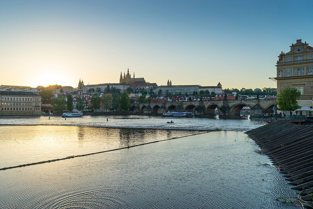 Sunset over the Vltava River looking towards St. Vitus's Cathedral and the Castle District, Prague, Czech Republic, Europe