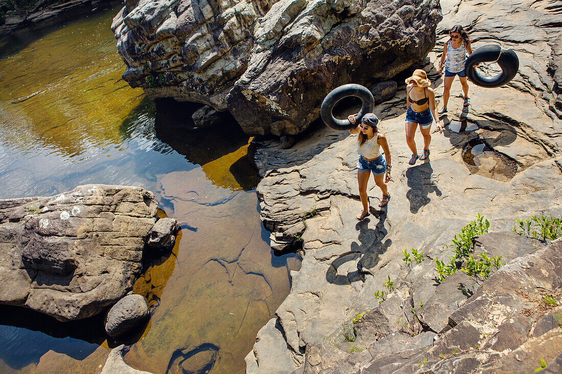 Three young women hike and play in the water at Little River Canyon National Reserve.