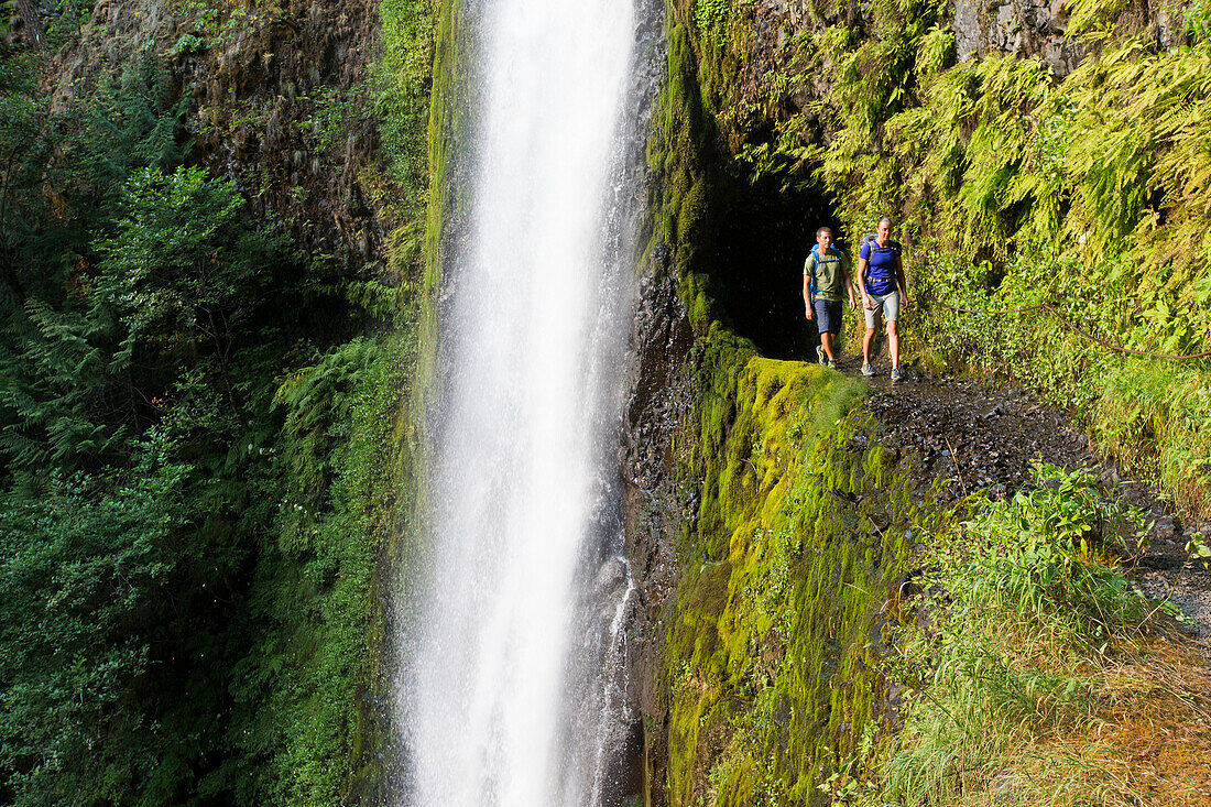 A couple hiking on the pacific crest trail at tunnel falls.