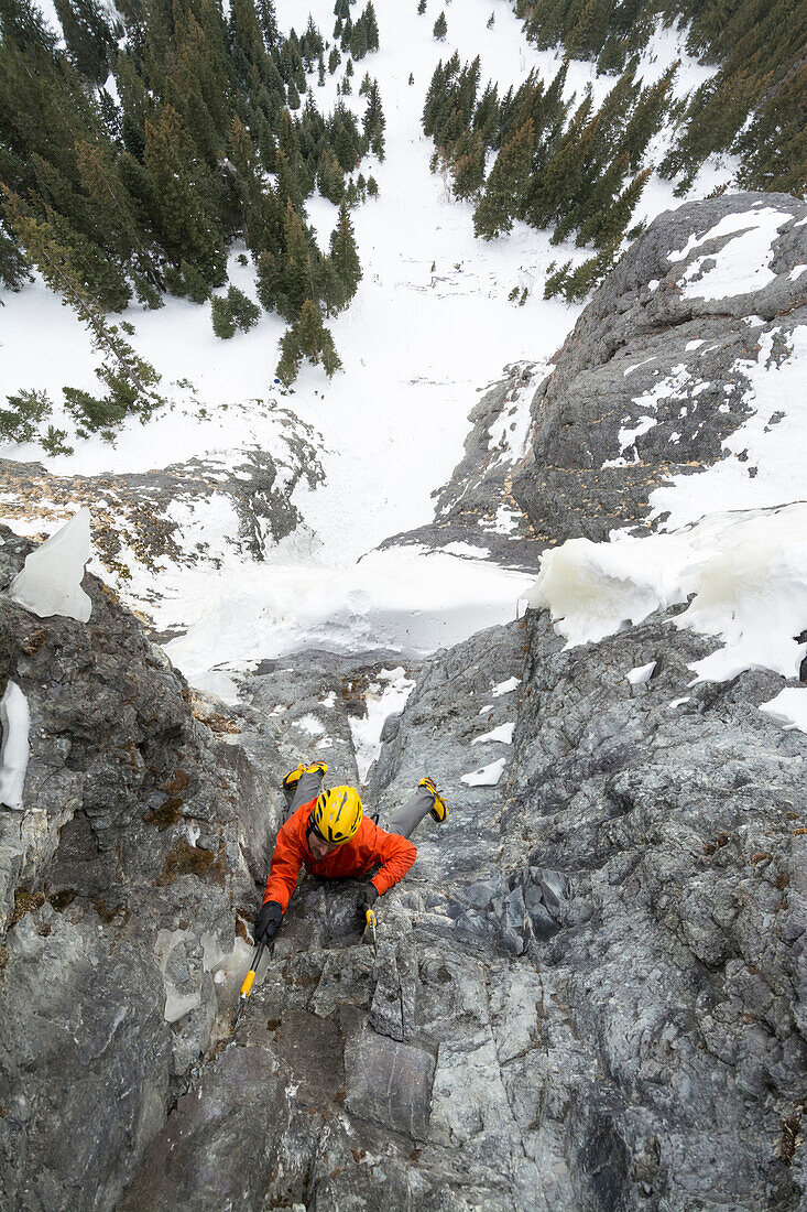 A man ice climbing a route called The Talisman along the Camp Bird Road near Ouray, Colorado.