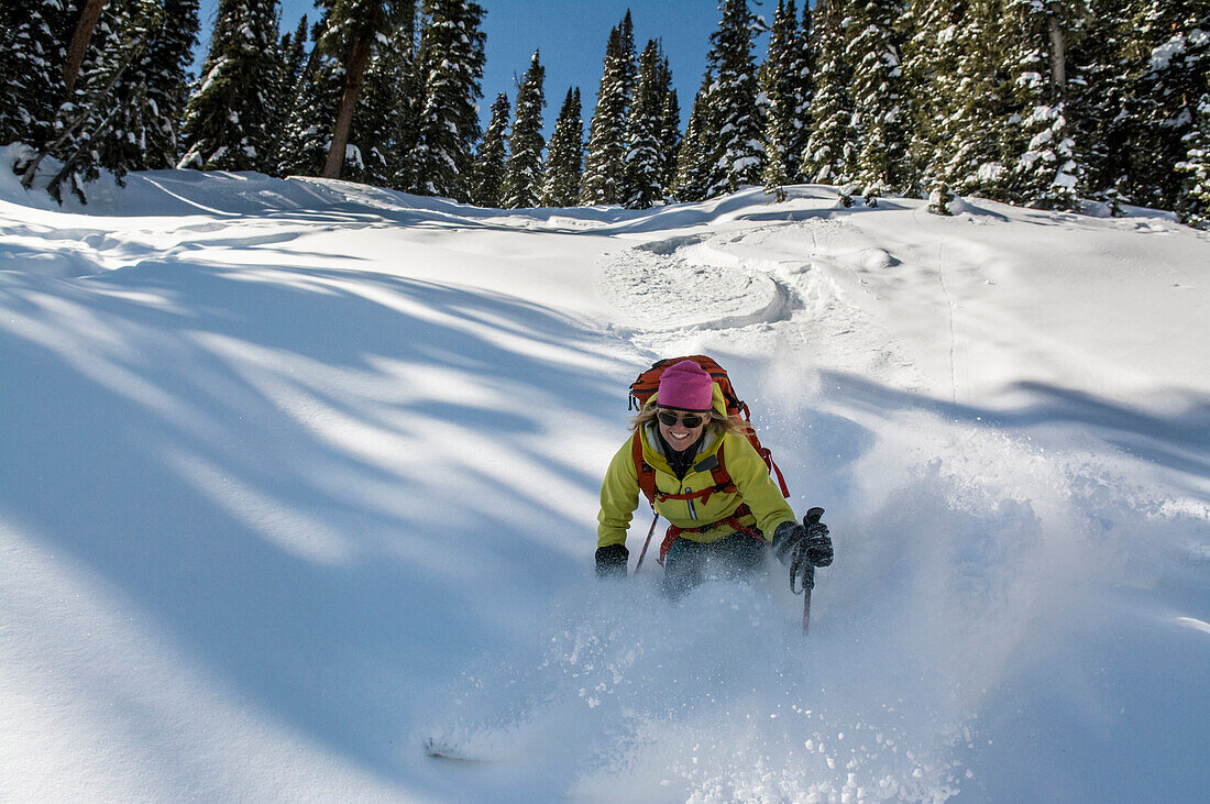 A woman backcountry skiing in Deer Creek, San Juan National Forest, Durango, Colorado.