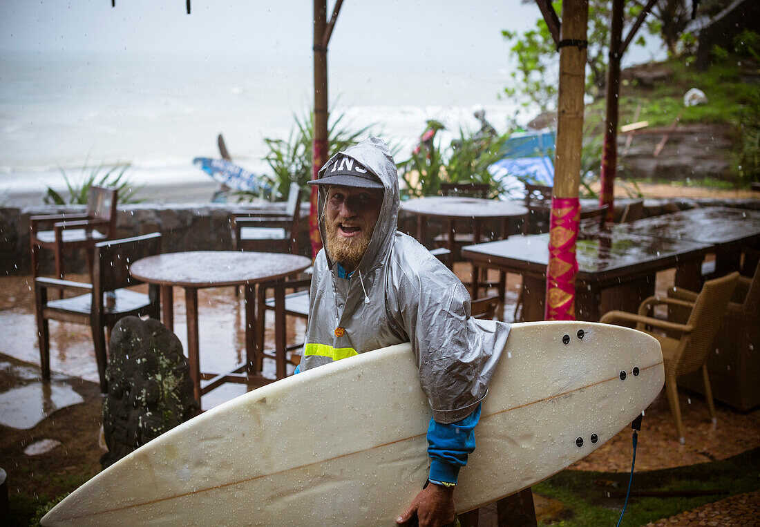 Surfer under a rain, Bali, Indonesia.