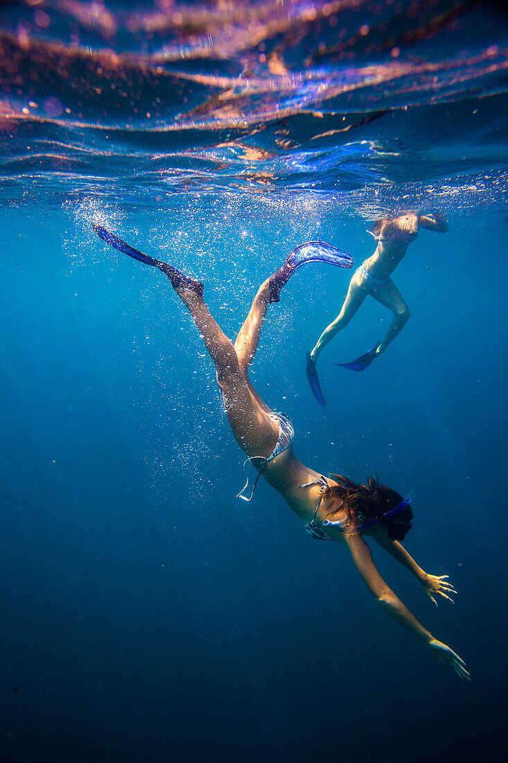Two Young Woman Snorkeling in Ocean.