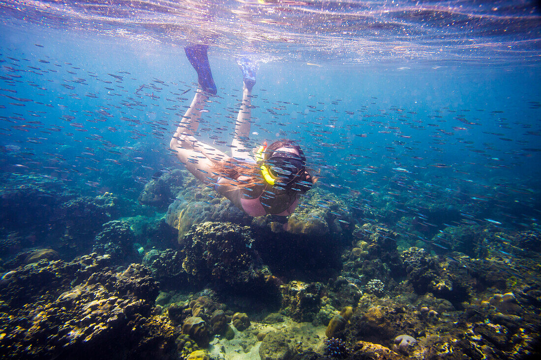Young woman snorkeling in ocean.