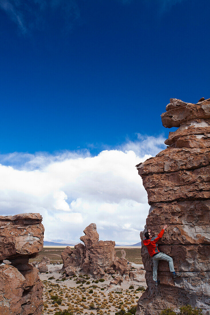 A young man plays on the rocks in the Atacama Desert. The Salar de Uyuni is the world's largest salt flat and home to one of the largest deposits of lithium in the world. The communities surrounding this region could potentially benefit greatly or suffer 