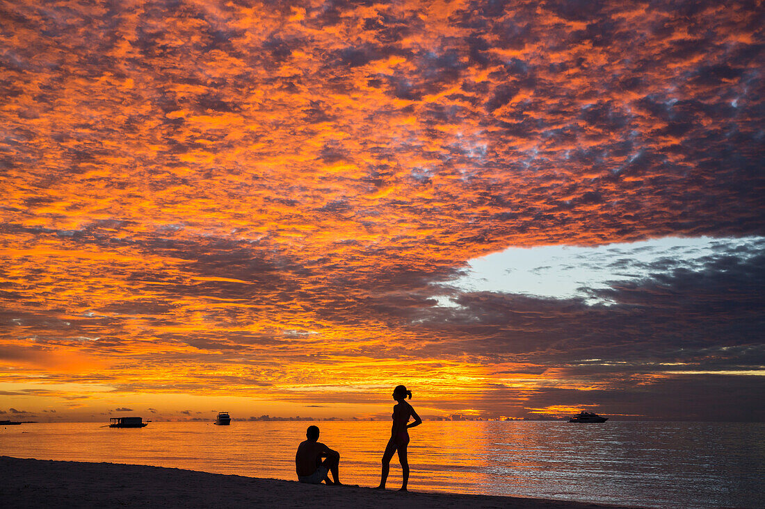 Sunset with two people at Meeru Island Resort, Meerufenfushi, North-Male-Atoll, Maldives