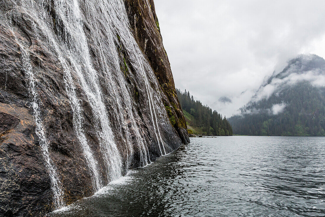 Water cascading down cliffs in Misty Fjord National Park, Alaska, United States of America, North America