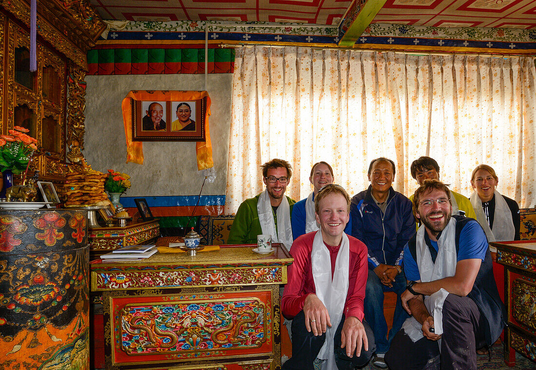 King's audience with the King's son in the middle, Hikers, trekkers in the audience room of the King's Palace in Lo Manthang (3840 m), former capital of the Kingdom of Mustang and residence of King Raja Jigme Dorje Palbar Bista in the Kali Gandaki valley,