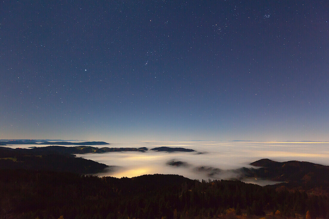 Starry sky over fog in the Rhine valley, view from Schwarzwaldhochstrasse, Black Forest, Baden-Wuerttemberg, Germany