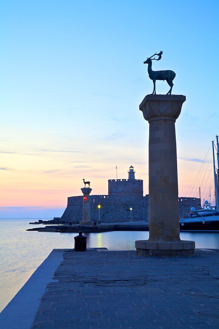 Bronze Doe and Stag statues at the entrance of Mandraki Harbour, Rhodes, Dodecanese, Greek Islands, Greece, Europe