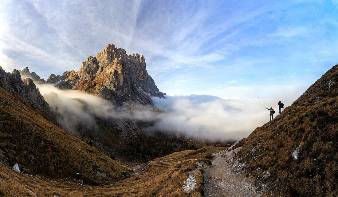 Hikers admire the peaks of Forcella De Furcia at sunrise, Funes Valley, South Tyrol, Dolomites, Italy, Europe