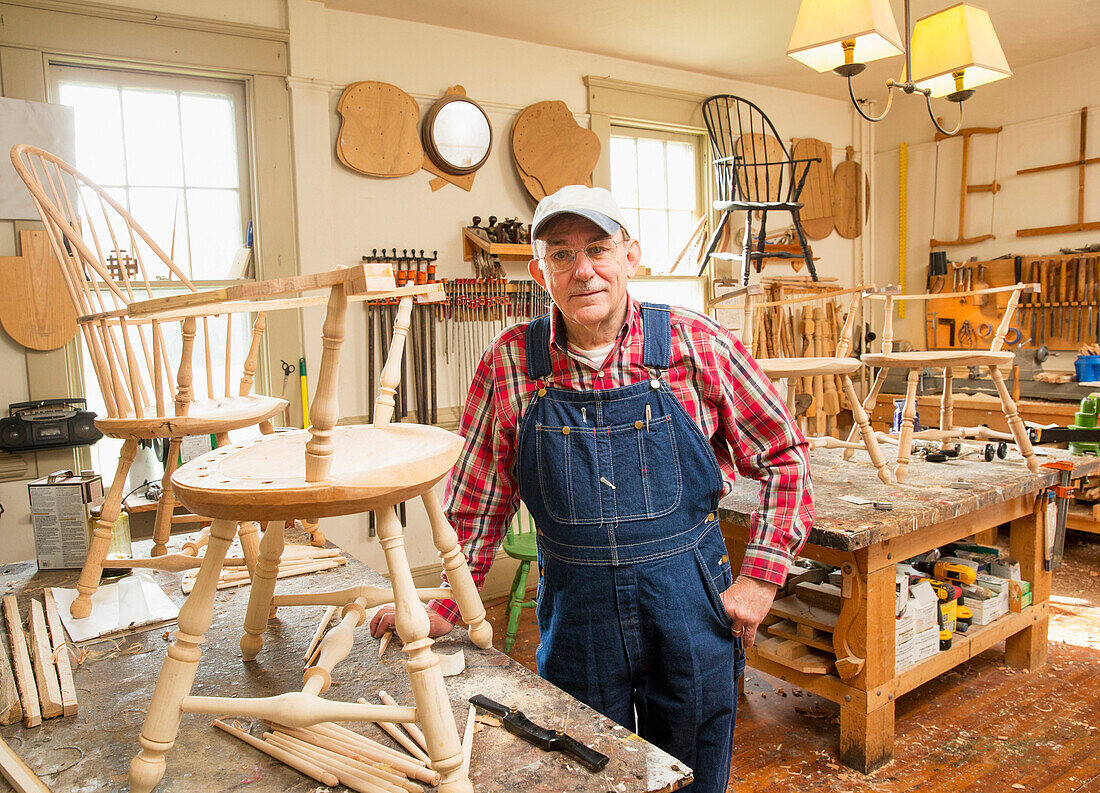 Caucasian carpenter building chair in workshop