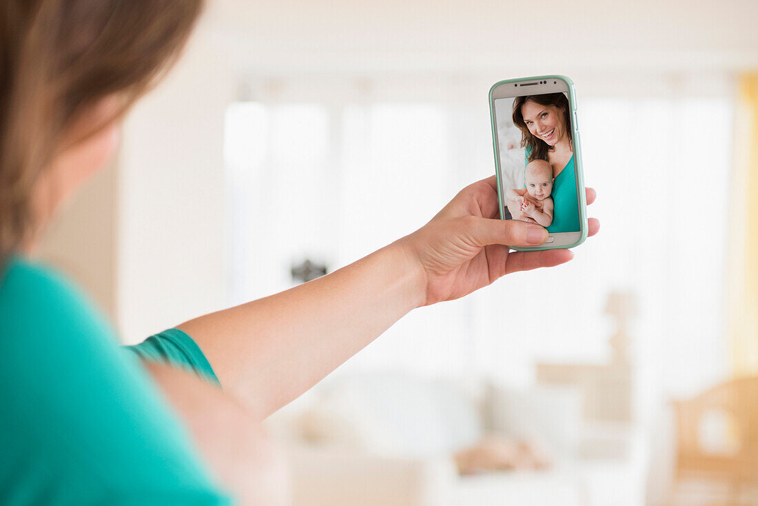 Mother taking selfie with baby daughter
