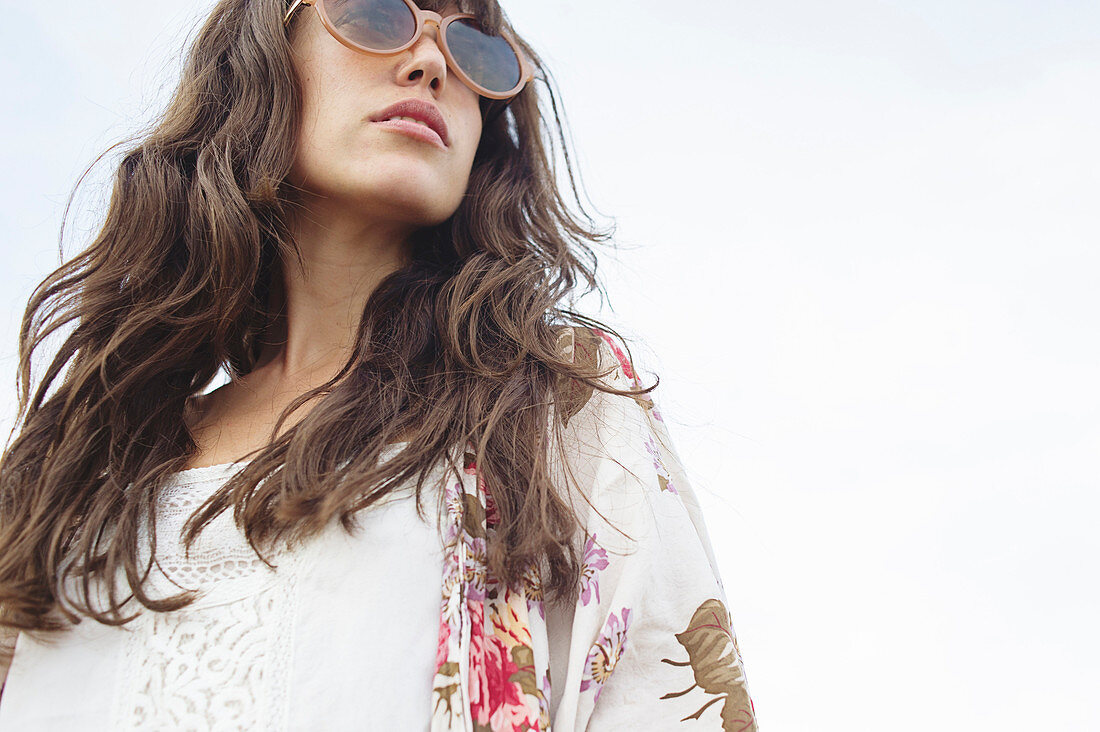 Low angle view of Caucasian woman wearing sunglasses outdoors