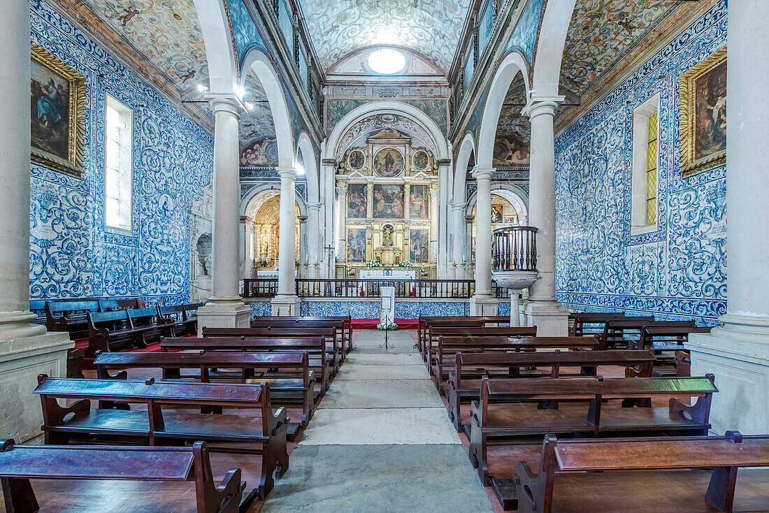 Ornate arches and pews in Iglesia de Santa Maria, Obidos, Leiria, Portugal