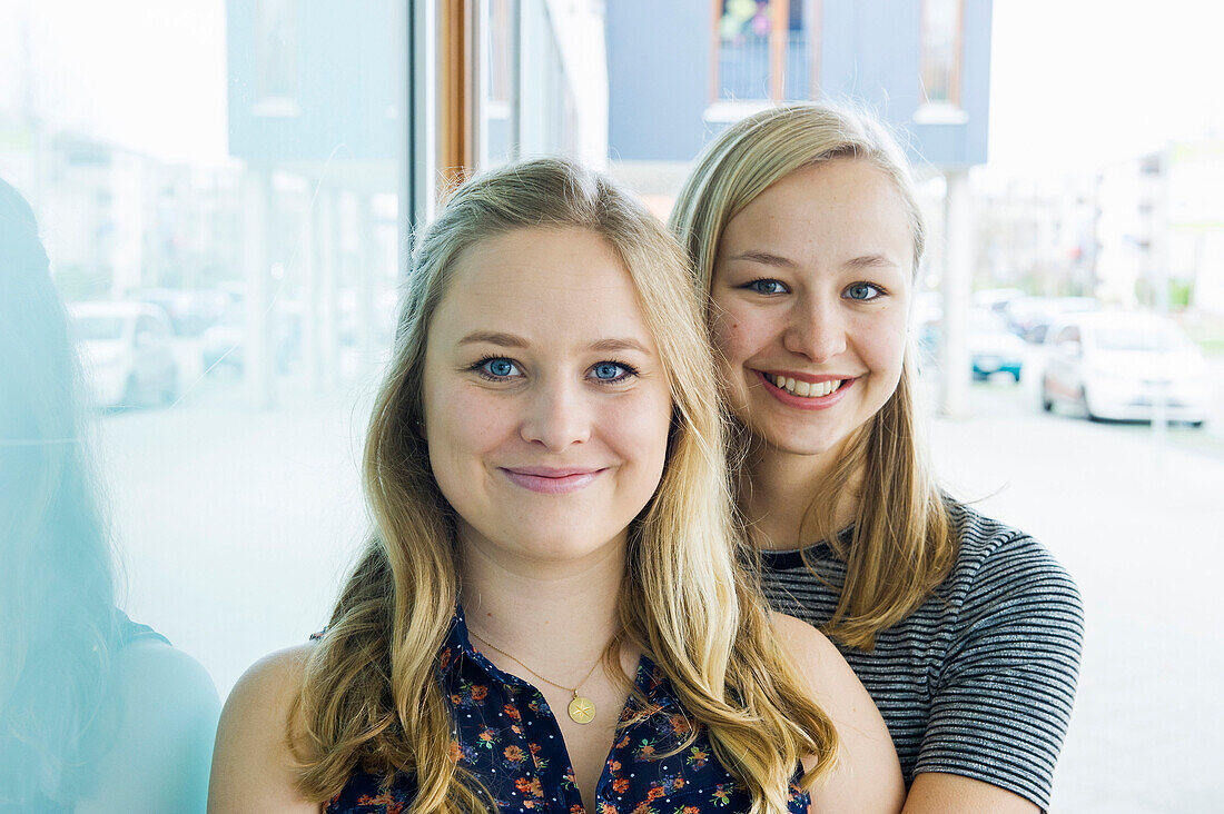 smiling young women, sisters, Germany