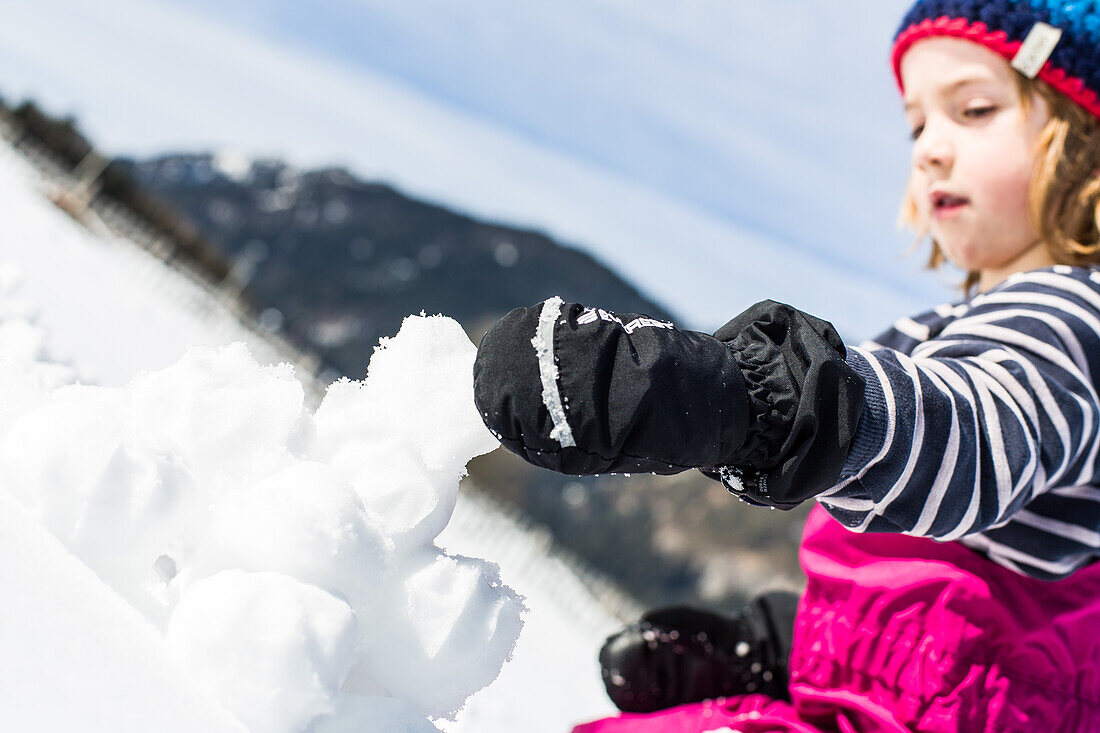 boy forming snowballs in winter, Pfronten, Allgaeu, Bavaria, Germany