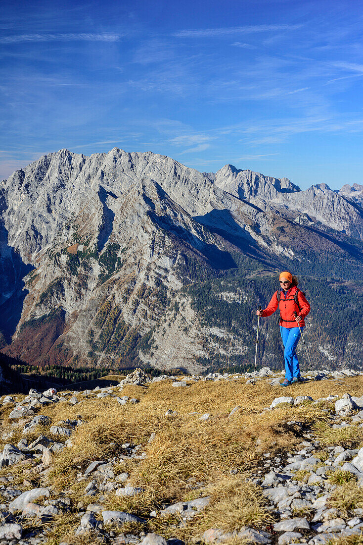 Woman hiking towards Schneibstein, Watzmann and Hochkalter in background, view from Schneibstein, Schneibstein, Berchtesgaden Alps, Upper Bavaria, Bavaria, Germany