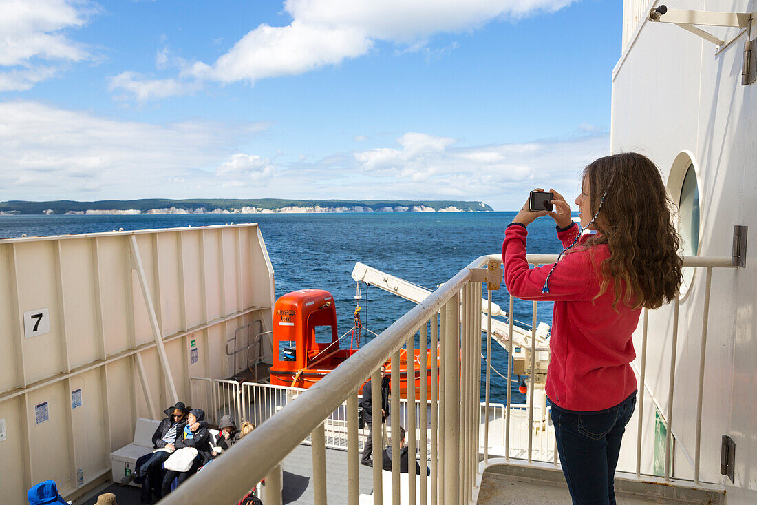 Baltic sea, ferry, transfer from Germany to Denmark, girl taking photos with her mobile phone, chalk cliffs, Ruegen island, Mecklenburg-West Pomerania, Germany, Europe