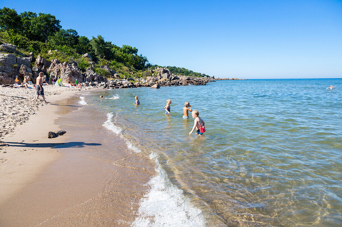 Family bathing in the sea, Sandkas beach, Summer, Holiday, Baltic sea, Bornholm, south of Sandvig and Allinge, east coast, Denmark, Europe