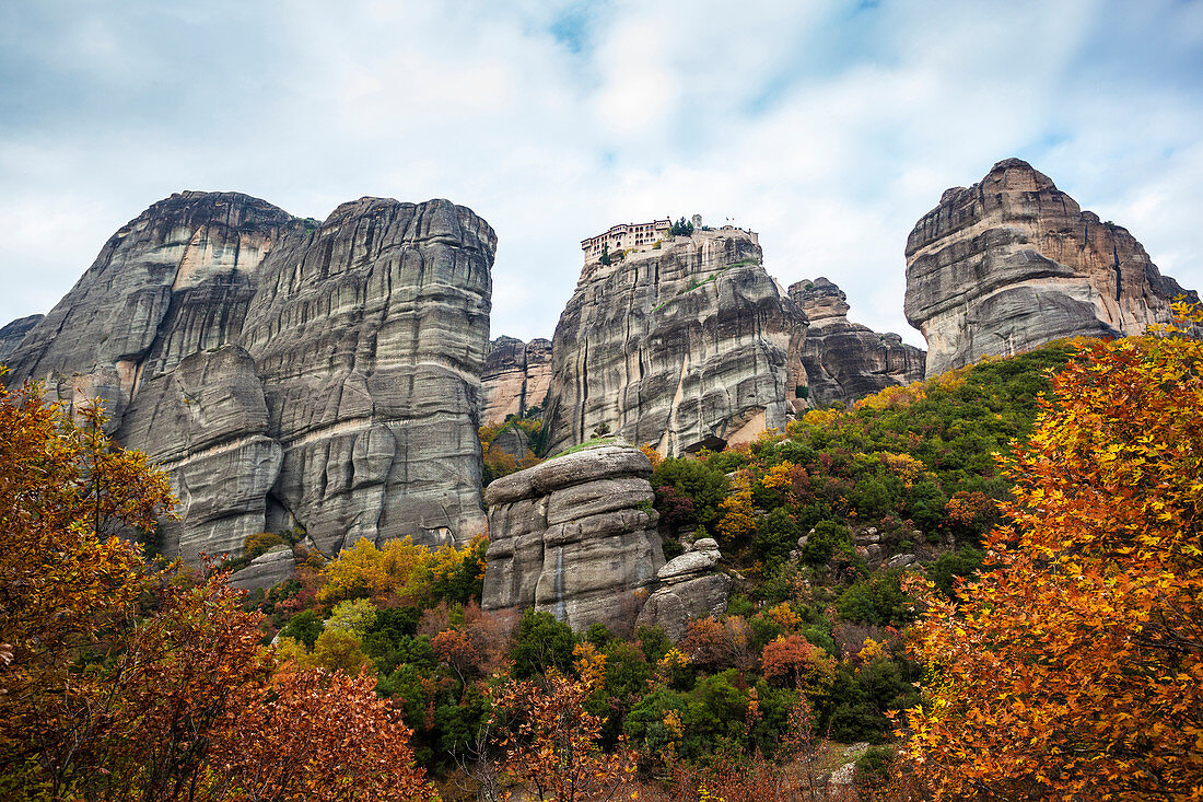 Monastery perched on a cliff with autumn foliage, Meteora, Greece