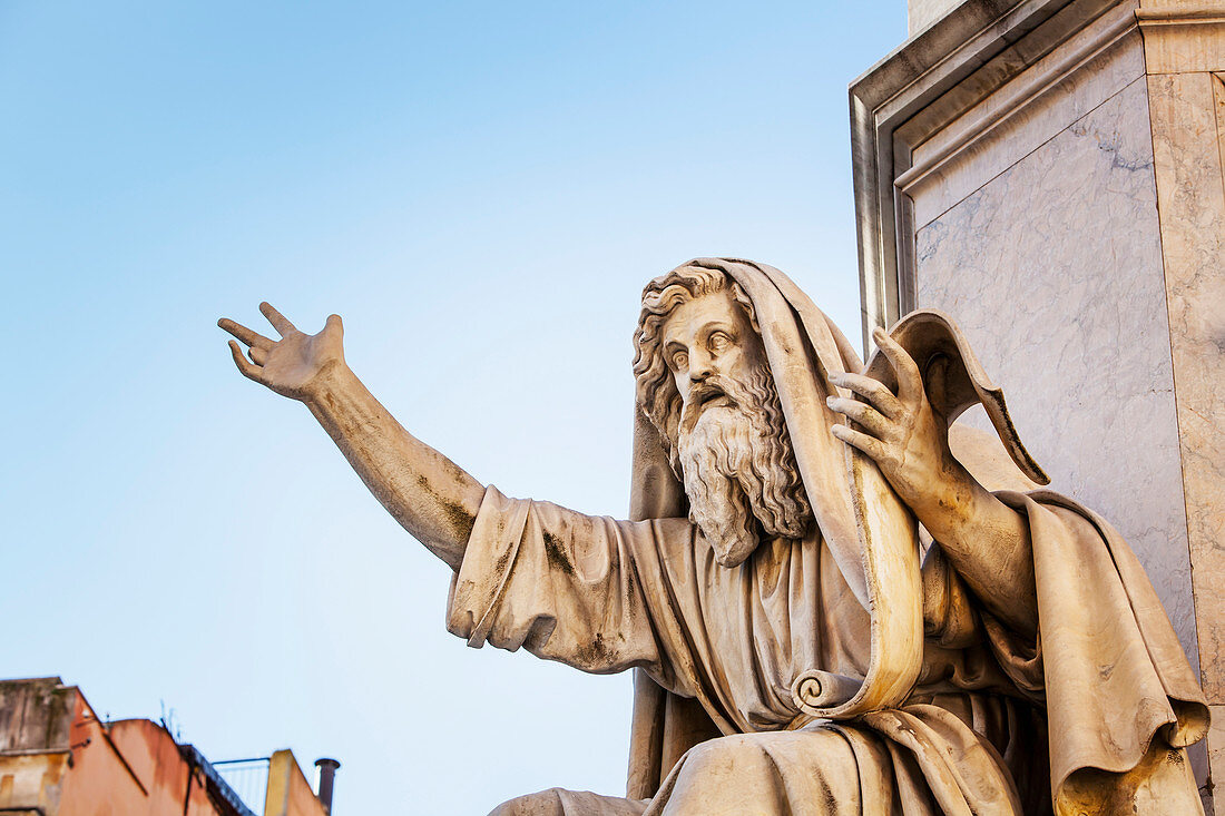 Statue of historical male figure holding a scroll and speaking, Rome, Italy