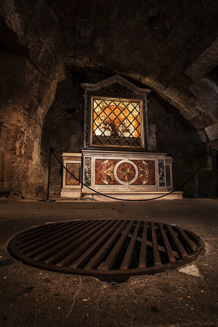 Inside the Mamertine Prison, this metal grate in the floor covers where the prisoners were lowered into their prison cell, Rome, Italy